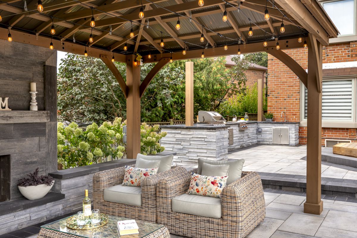 Enhance your Landscaping with a stunning gazebo featuring wicker furniture and a cozy fire pit.